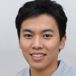 Joyful asian young-adult male with short  black hair and brown eyes