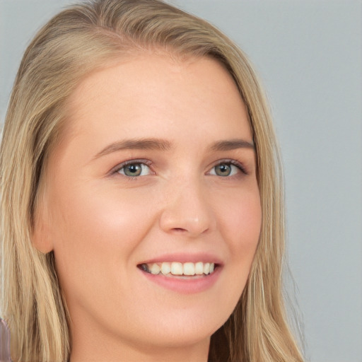 Joyful white young-adult female with long  blond hair and brown eyes