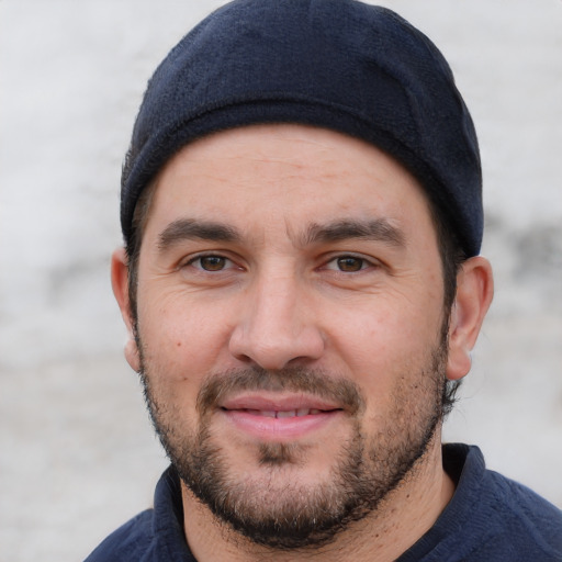 Joyful white young-adult male with short  black hair and brown eyes