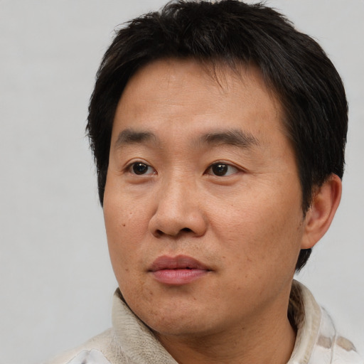 Neutral asian adult male with short  brown hair and brown eyes
