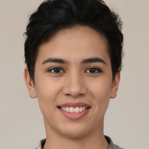 Joyful latino young-adult female with short  black hair and brown eyes