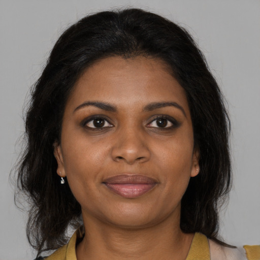 Joyful black young-adult female with medium  brown hair and brown eyes