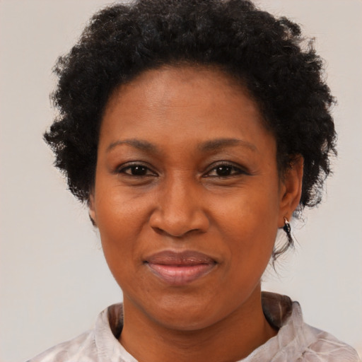 Joyful black adult female with short  brown hair and brown eyes