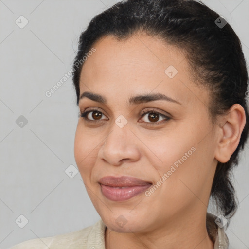 Joyful latino young-adult female with medium  brown hair and brown eyes