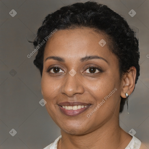 Joyful black young-adult female with short  brown hair and brown eyes