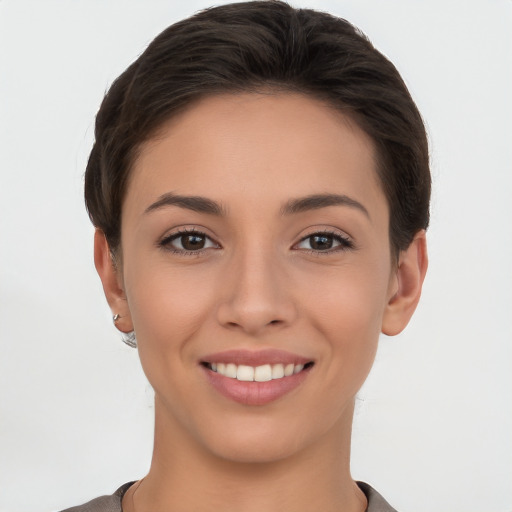 Joyful white young-adult female with short  brown hair and brown eyes