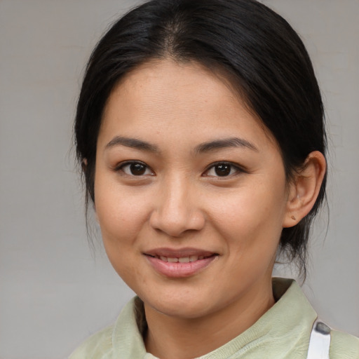 Joyful asian young-adult female with medium  brown hair and brown eyes