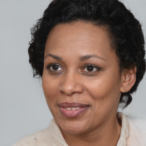 Joyful black adult female with short  brown hair and brown eyes