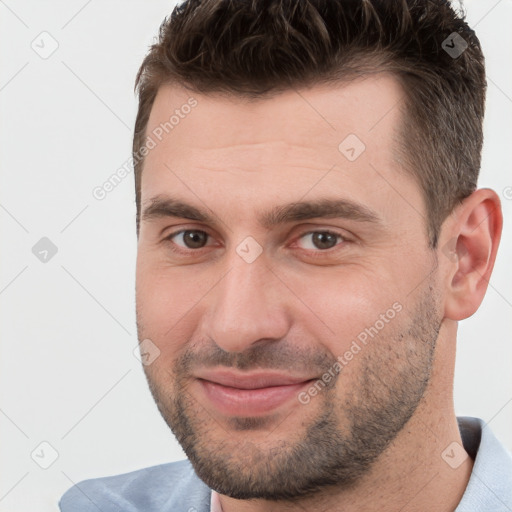 Joyful white adult male with short  brown hair and brown eyes