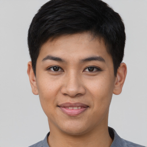 Joyful asian young-adult male with short  brown hair and brown eyes