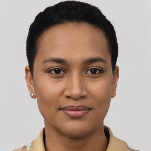 Joyful latino young-adult female with short  black hair and brown eyes