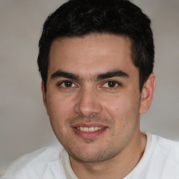 Joyful white young-adult male with short  black hair and brown eyes