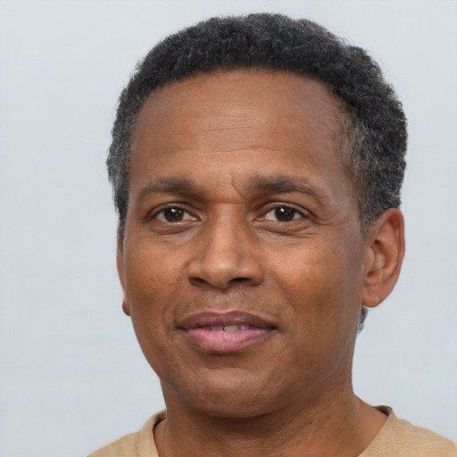 Joyful black adult male with short  brown hair and brown eyes