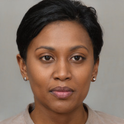 Joyful black young-adult female with short  brown hair and brown eyes