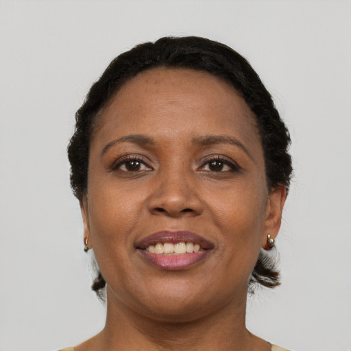 Joyful black adult female with short  brown hair and brown eyes