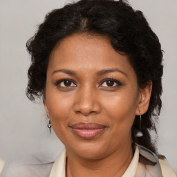 Joyful black adult female with medium  brown hair and brown eyes