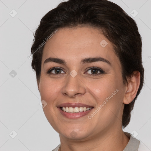 Joyful white young-adult female with short  brown hair and brown eyes