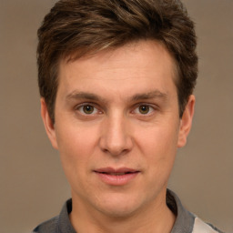 Joyful white adult male with short  brown hair and brown eyes