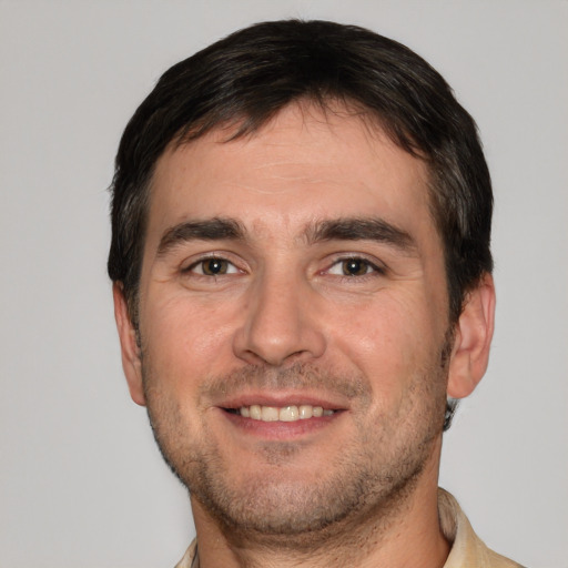 Joyful white young-adult male with short  brown hair and brown eyes