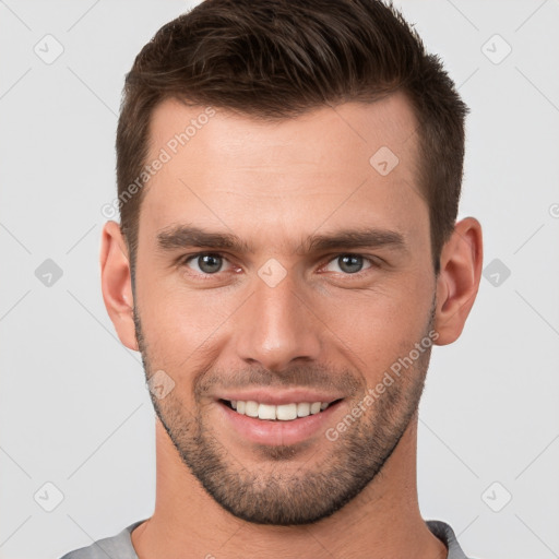 Joyful white young-adult male with short  brown hair and brown eyes