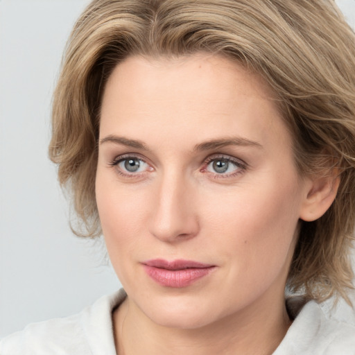 Joyful white young-adult female with medium  brown hair and blue eyes