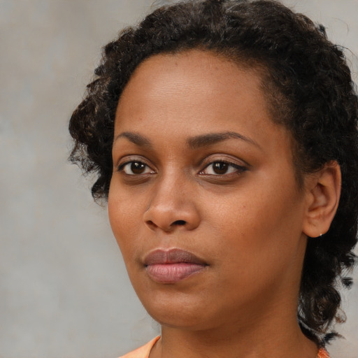 Neutral black young-adult female with short  black hair and brown eyes