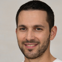 Joyful white young-adult male with short  brown hair and brown eyes