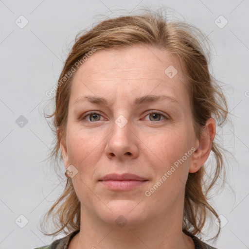 Joyful white young-adult female with medium  brown hair and blue eyes