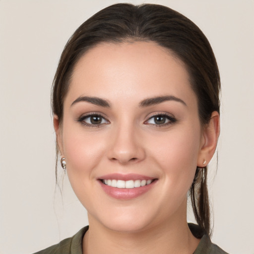 Joyful white young-adult female with long  brown hair and brown eyes