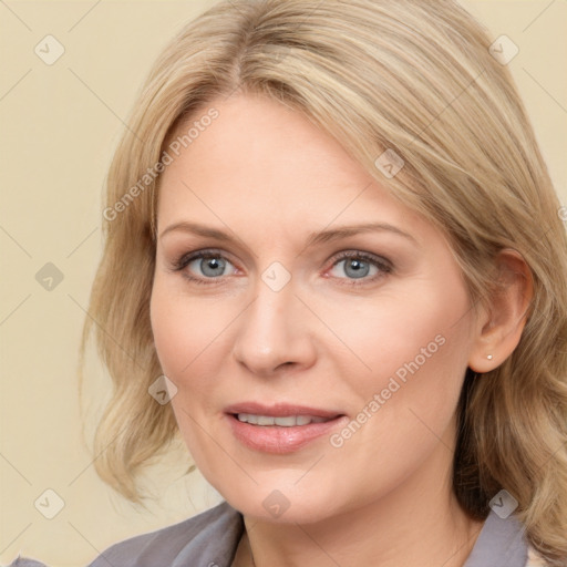 Joyful white adult female with medium  brown hair and blue eyes