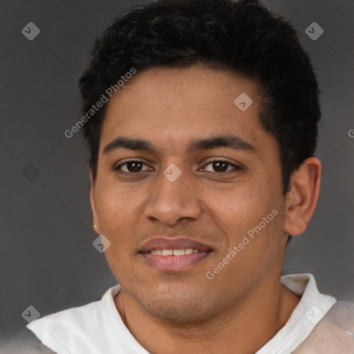 Joyful latino young-adult male with short  black hair and brown eyes