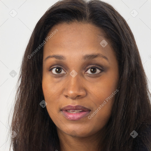 Joyful black young-adult female with long  brown hair and brown eyes