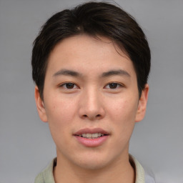 Joyful asian young-adult male with short  brown hair and brown eyes