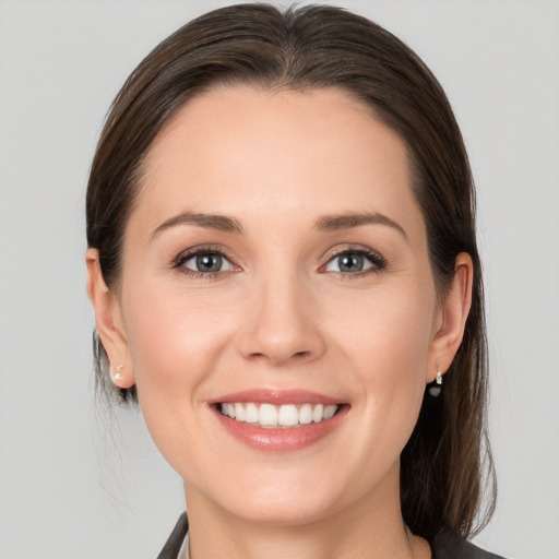 Joyful white young-adult female with medium  brown hair and brown eyes