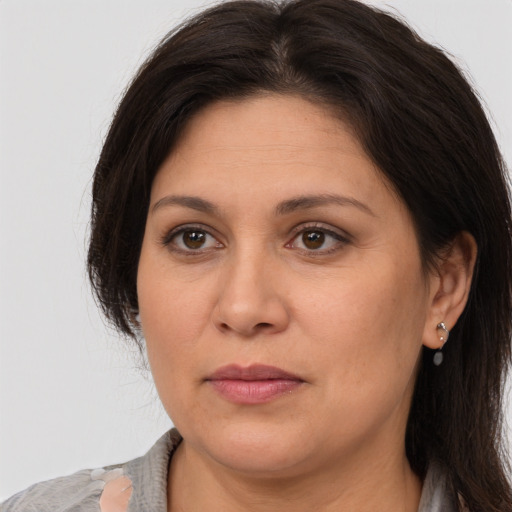 Joyful white adult female with medium  brown hair and brown eyes
