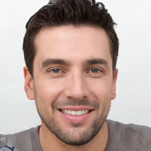 Joyful white young-adult male with short  brown hair and brown eyes