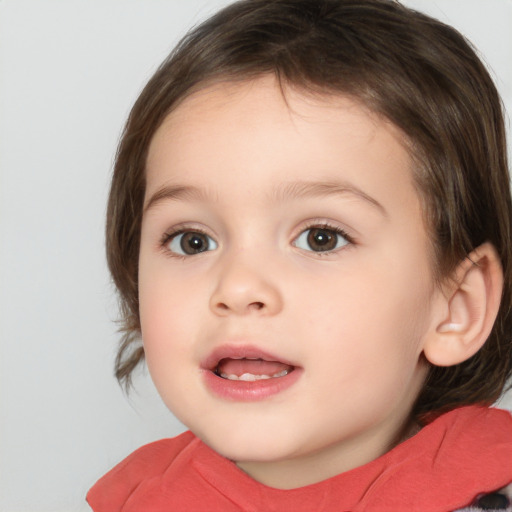 Joyful white child female with medium  brown hair and brown eyes