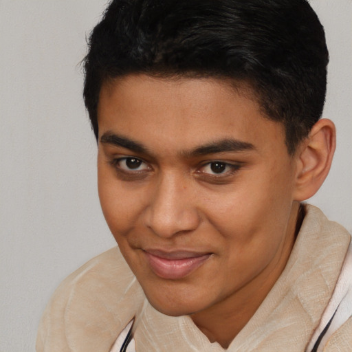 Joyful latino young-adult male with short  brown hair and brown eyes