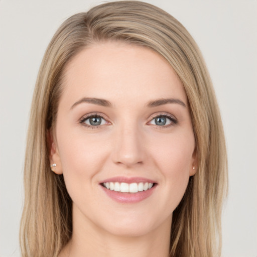 Joyful white young-adult female with long  brown hair and blue eyes