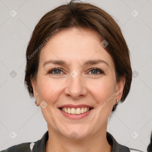 Joyful white adult female with medium  brown hair and grey eyes