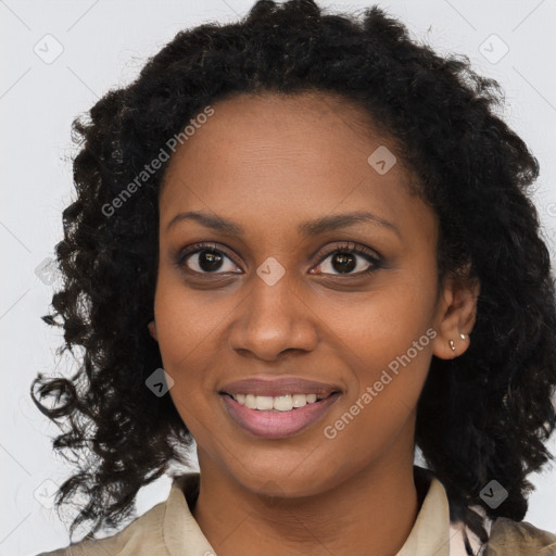 Joyful black young-adult female with long  brown hair and brown eyes