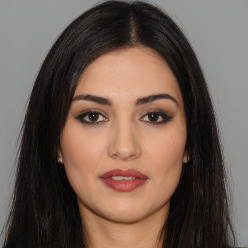 Joyful white young-adult female with long  black hair and brown eyes