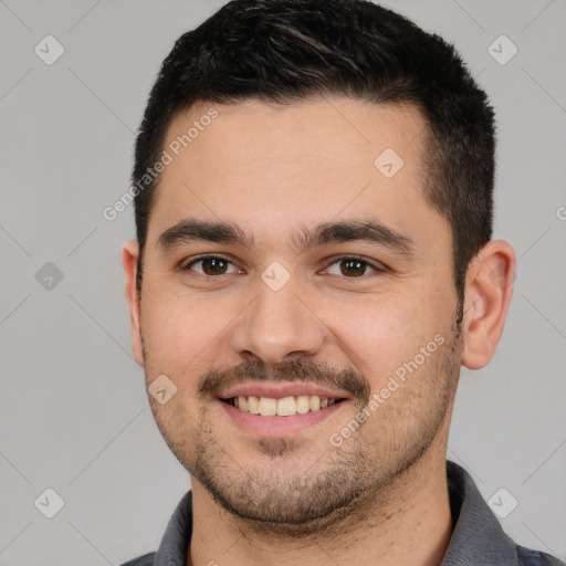 Joyful white young-adult male with short  black hair and brown eyes