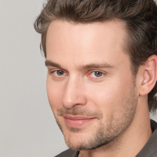 Joyful white adult male with short  brown hair and brown eyes