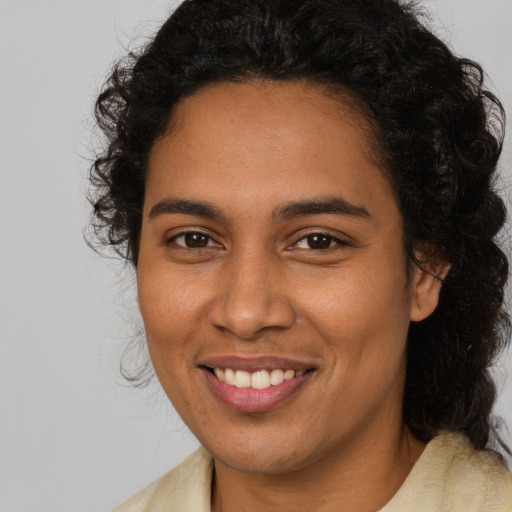 Joyful latino young-adult female with medium  brown hair and brown eyes