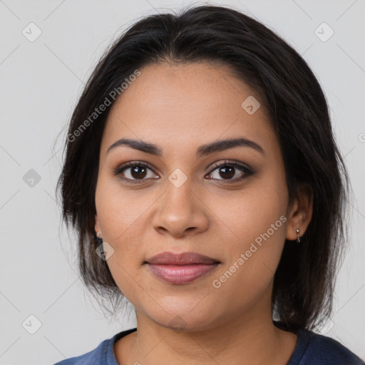 Joyful latino young-adult female with medium  brown hair and brown eyes