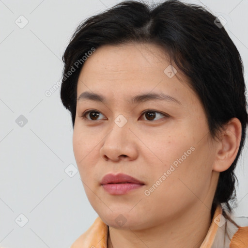 Joyful asian young-adult female with short  brown hair and brown eyes