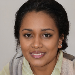 Joyful black young-adult female with medium  brown hair and brown eyes