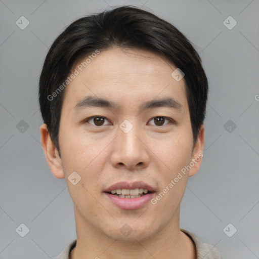 Joyful asian young-adult male with short  brown hair and brown eyes