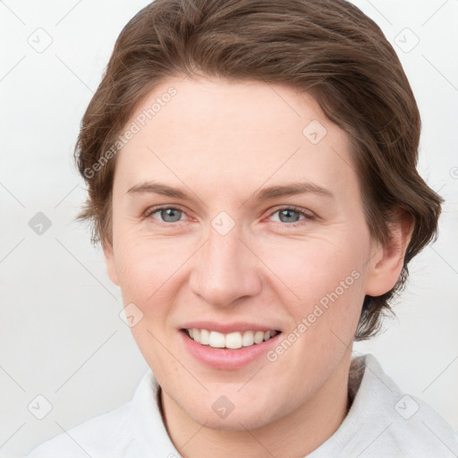 Joyful white young-adult female with short  brown hair and grey eyes